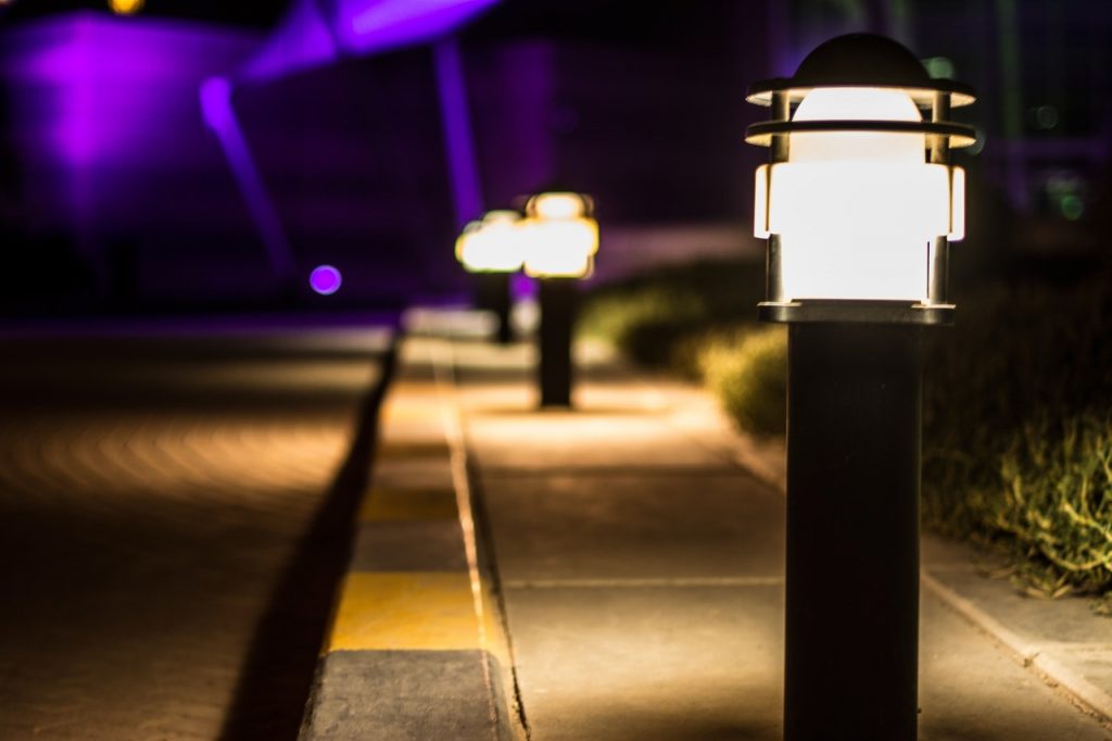 What are the benefits of using solar lights in outdoor premises?